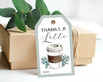 May include: A white gift tag with a gray border and a brown coffee cup illustration. The text on the tag reads "Thanks a Latte" and "From:".