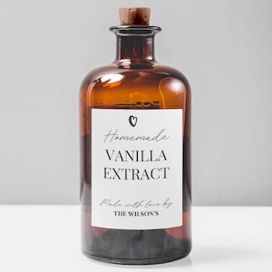 May include: A brown glass bottle with a cork stopper and a white label that reads "Homemade Vanilla Extract Made with love by THE WILSON'S".