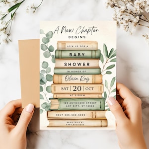 May include: Baby shower invitation featuring a stack of books with green and beige tones, adorned with eucalyptus leaves. The invitation reads "A New Chapter Begins" and includes event details, such as the date, time, and location.