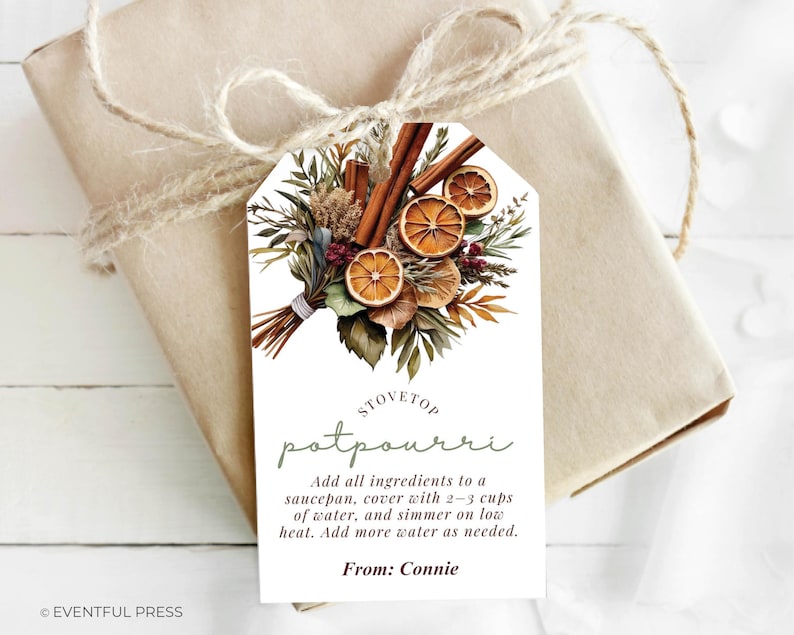 May include: A gift tag with a watercolor illustration of dried oranges, cinnamon sticks, and greenery. The tag reads "STOVETOP potpourri" with instructions and the name "Connie". The tag is tied to a wrapped gift with twine.