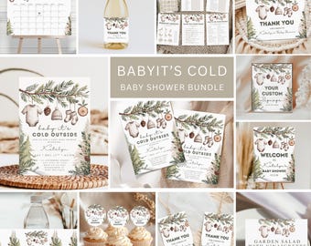 May include: A collection of baby shower stationery with a winter theme. Includes invitations, thank you cards, cupcake toppers, and a calendar. The designs feature illustrations of baby clothes, pine cones, and greenery. The text "Baby It's Cold Outside" is visible.