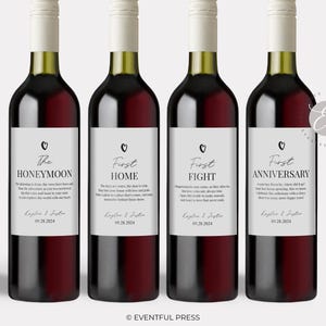 May include: Four wine bottles with white labels featuring black text and a small heart icon. The labels are titled The Honeymoon, First Home, First Fight, and First Anniversary, each including the names Kaylee & Justin and the date 09.28.2024.