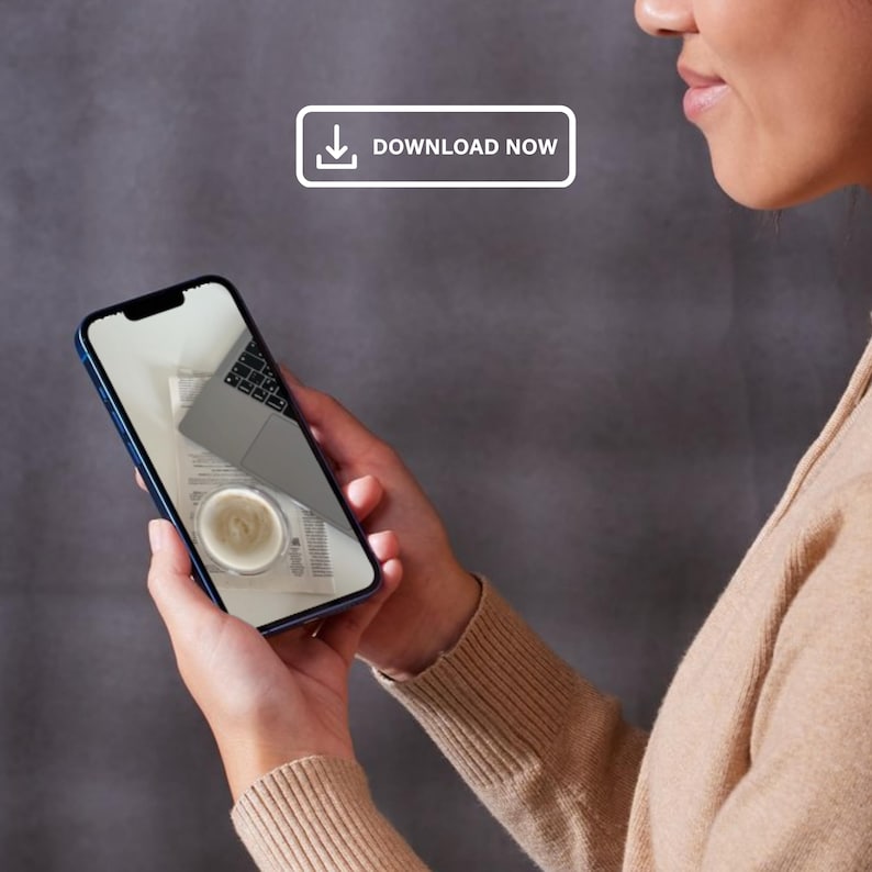 May include: A person is holding a smartphone displaying a photo of a laptop, a cup of coffee, and papers. The text "DOWNLOAD NOW" is displayed on the screen.