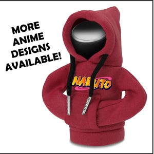 May include: A red bottle stopper shaped like a hoodie, featuring the word "NARUTO" in a colorful design. The hoodie has black drawstrings and silver tips. Text on the left says "MORE ANIME DESIGNS AVAILABLE!"