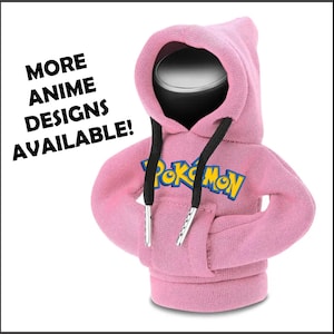 May include: A pink hooded sweatshirt with the word "Pokemon" in yellow and blue lettering. The hoodie has black drawstrings and silver aglets. The text "MORE ANIME DESIGNS AVAILABLE!" is printed on the left side.