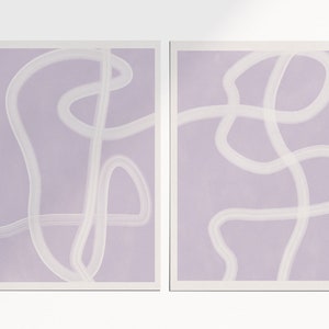 May include: Two abstract art prints with a light purple background and white lines. The lines are curved and create a flowing, organic design.