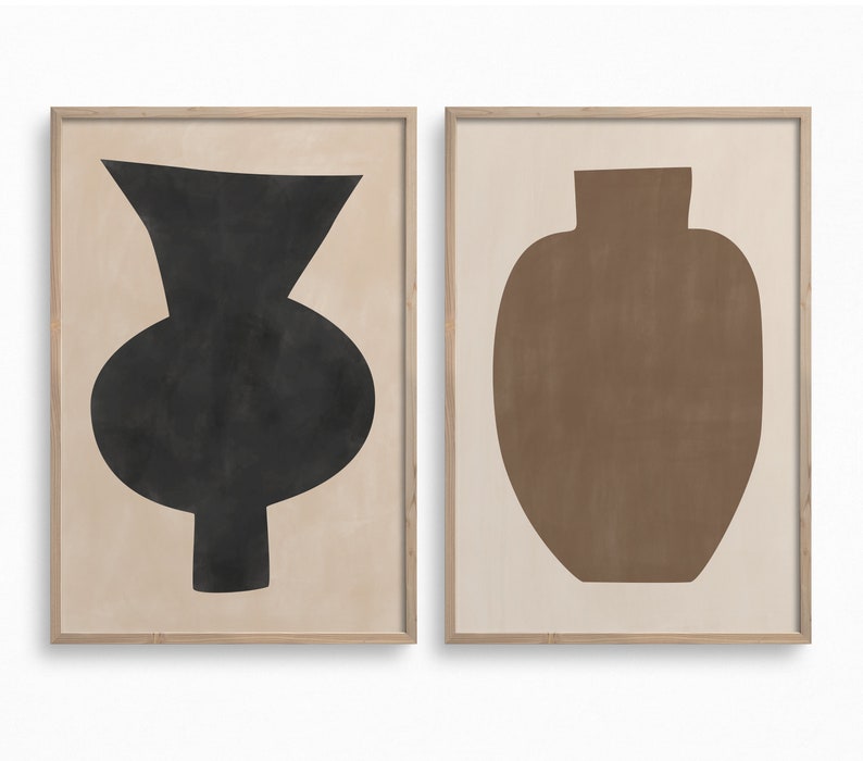 May include: Two framed prints of abstract vase shapes. The left print features a black vase with a rounded body and a narrow neck. The right print features a brown vase with a rounded body and a wide neck.
