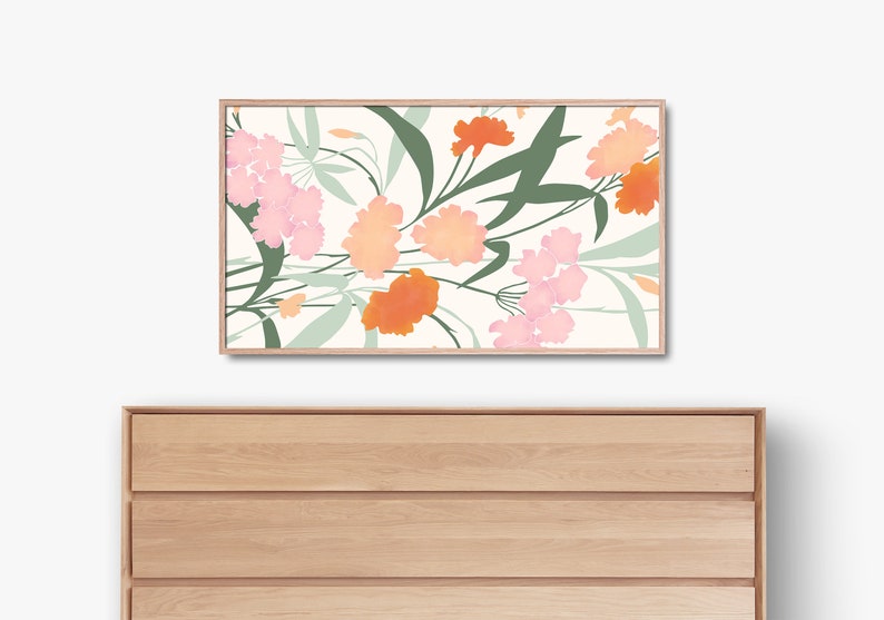 May include: A framed print with a floral design featuring pink, orange, and green flowers on a white background.