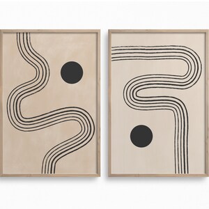 Puede incluir: Dos impresiones enmarcadas con un fondo beige y dise&ntilde;os abstractos de l&iacute;neas negras. Cada impresi&oacute;n presenta un c&iacute;rculo negro.