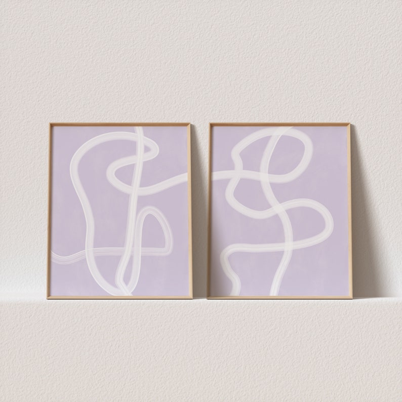 May include: Two framed abstract art prints with white lines on a light purple background.