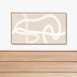 Puede incluir: Una impresi&oacute;n de arte abstracto enmarcada con l&iacute;neas blancas sobre un fondo beige. La impresi&oacute;n est&aacute; colgada sobre una c&oacute;moda de madera con cuatro cajones.