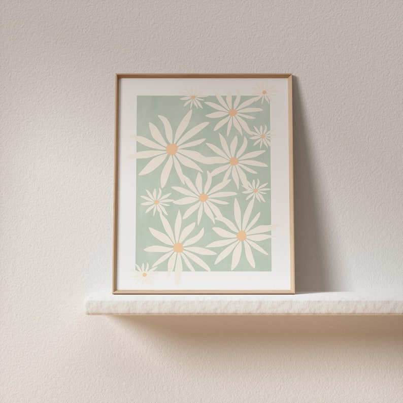 May include: A framed print with a minimalist design featuring white daisies on a light green background.