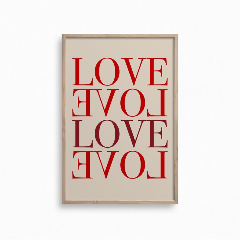 May include: A framed print with the word "LOVE" repeated four times, each time rotated 90 degrees clockwise. The background is a light beige color and the text is in red.