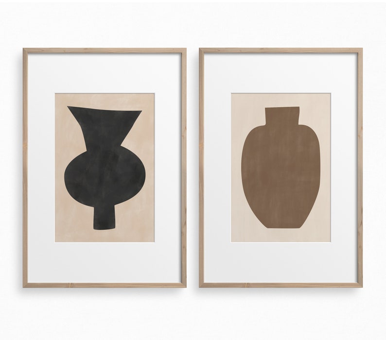 May include: Two framed prints of abstract vase silhouettes. The left print features a black vase with a rounded base and a narrow neck. The right print features a brown vase with a rounded base and a wide neck.
