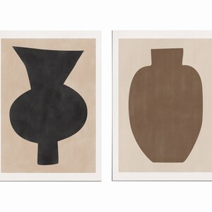 May include: Two minimalist art prints featuring abstract vase silhouettes. The left print has a black vase on a beige background. The right print has a brown vase on a beige background.
