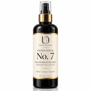 May include: A dark amber spray bottle of Unique Organics Crown Serum No. 7 Melatonin Scalp Mist. The label features black text on a cream background, stating Refresh, Balance, Replenish, and 8 FL OZ / 236 mL. It has a clear plastic spray nozzle.