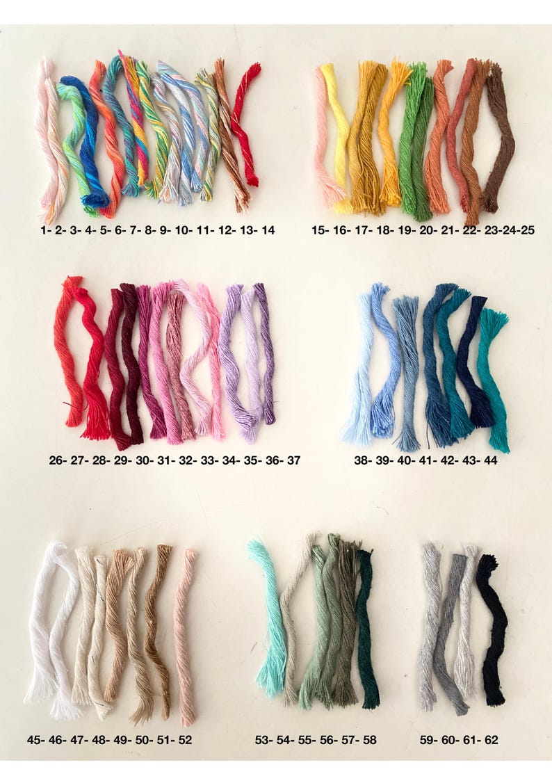May include: A collection of 62 bundles of colorful embroidery floss, arranged in rows. The floss colors range from white to black, with various shades of pink, red, orange, yellow, green, blue, and purple. Each bundle is labeled with a number.