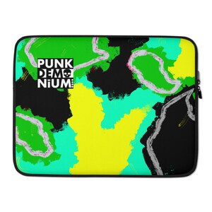 May include: A black laptop sleeve with a colorful abstract design featuring green, yellow, and blue paint splatters. The text "PUNK DEMONIUM" is printed in white on a black rectangle in the upper left corner.