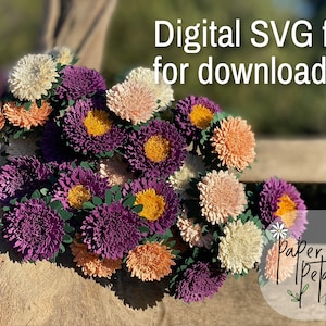 Puede incluir: Un archivo SVG digital para descargar de un ramo de flores de papel. Las flores son en tonos de morado, rosa, blanco y naranja. Las flores están dispuestas en un racimo sobre una superficie de madera. El texto "Paper Petals by Hndi" es visible en la esquina inferior derecha de la imagen.