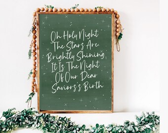 May include: A green chalkboard with a wooden frame and a white inscription that reads "Oh Holy Night The Stars Are Brightly Shining It Is The Night Of Our Dear Savior's Birth".