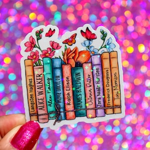 May include: A sticker featuring a stack of books with the names of authors printed on the spines. The books are surrounded by colorful flowers and butterflies. The sticker has a glittery finish.