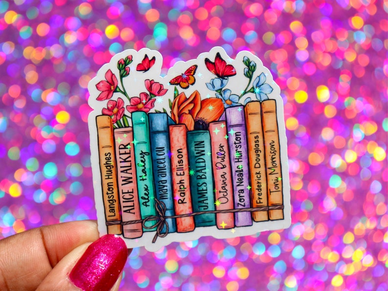 May include: A sticker featuring a stack of books with the names of authors printed on the spines. The books are surrounded by colorful flowers and butterflies. The sticker has a glittery finish.
