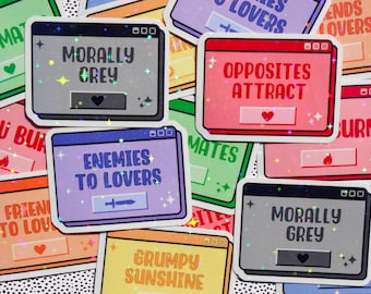 May include: A set of nine colorful stickers with different sayings. The stickers are in the shape of computer windows and have a glittery finish. The sayings include "Morally Grey", "Enemies to Lovers", "Opposites Attract", "Grumpy Sunshine", and "Friends to Lovers".