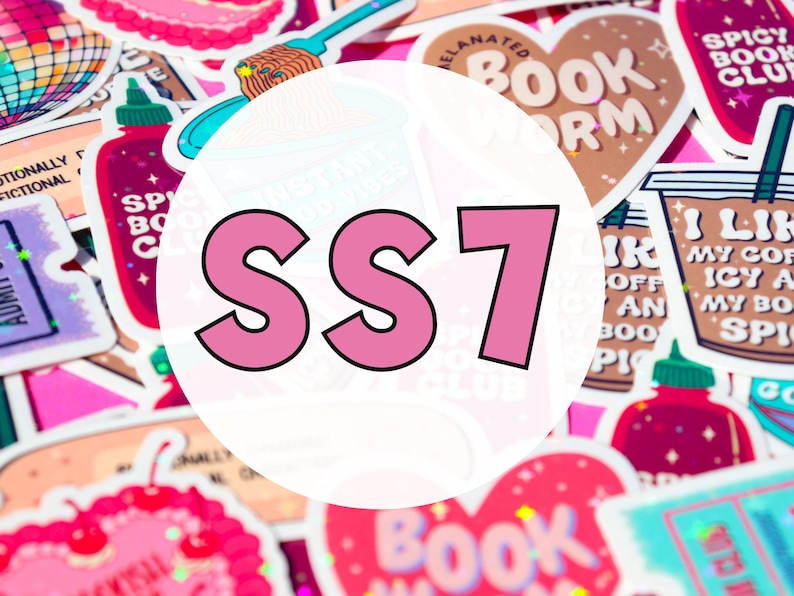 May include: A close-up of a variety of colorful stickers with different designs and text. The stickers are arranged in a random pattern and include designs such as a heart, a book, a coffee cup, and a bottle of hot sauce. The text on the stickers includes "Bookworm", "Spicy Book Club", "I Like My Coffee Icy", and "SS7".