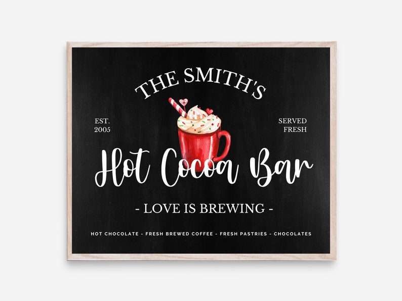 May include: A black chalkboard sign with white text that reads "The Smith's Est. 2005 Hot Cocoa Bar - Love is Brewing - Hot Chocolate - Fresh Brewed Coffee - Fresh Pastries - Chocolates" with a watercolor illustration of a red mug of hot cocoa with whipped cream, candy canes, and sprinkles.