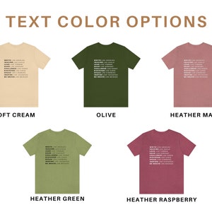 May include: Five t-shirts in different colours, including soft cream, olive, heather mauve, heather green, and heather raspberry. Each shirt features the same text printed in white: "WRITE LIKE ANGELS, IMAGINE LIKE GOD, DREAM LIKE CHILDREN, LEAD LIKE HUMAN, CHALLENGE LIKE KINGS, DISCOVER LIKE PIRATES, SPEAK LIKE YOUR HEART, INSPIRE LIKE YOUR SOUL, BE BRAVE LIKE LEGENDS".