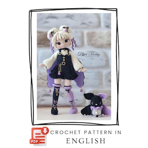 Puede incluir: Una muñeca de ganchillo con pelo rubio, vestida con un vestido de peto negro sobre una camisa blanca de manga larga y calcetines desiguales negros y morados. Junto a ella, un pequeño murciélago. Texto: Lort Hobby, CROCHET PATTERN IN ENGLISH.