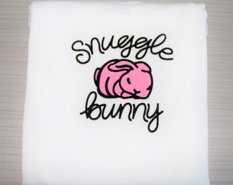 Baby girls' long sleeved white "Snuggle Bunny" bodysuit with cute pink baby bunny.