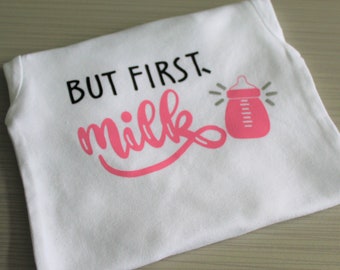 Baby girls' long sleeved "But first, milk" with baby bottle bodysuit.