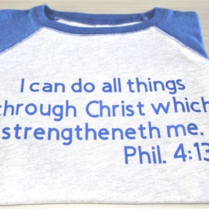 May include: A gray and blue baseball tee shirt with the text "I can do all things through Christ which strengtheneth me. Phil. 4:13" printed in blue.