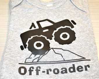 Infant boys short sleeved bodysuit with a monster truck on a hill and 'off roader' lettering.
