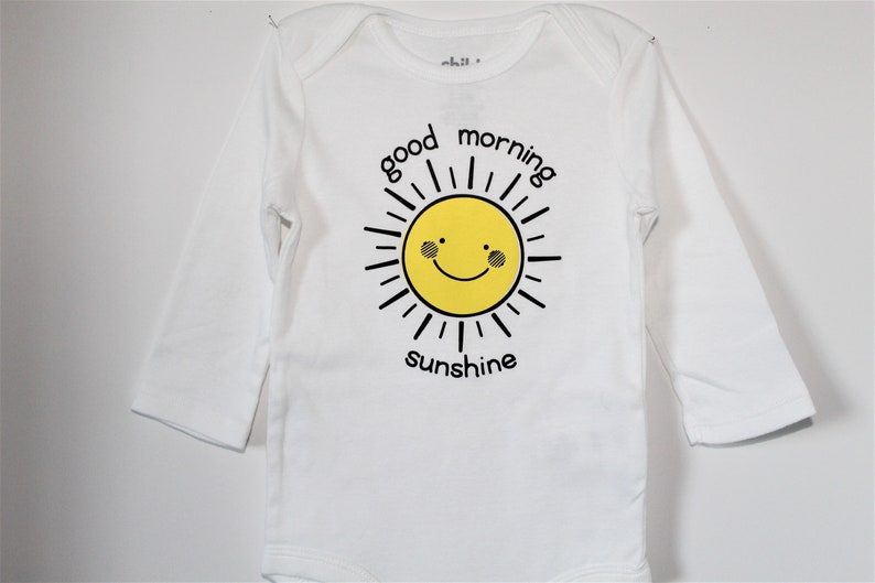 Infant boy/'sgirls/' long sleeved bodysuit with good morning sunshine lettering and yellow sun smiley face.