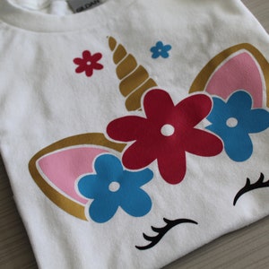 Toddler/Girls short-sleeved cotton t-shirt with an adorable unicorn face wearing a floral crown,