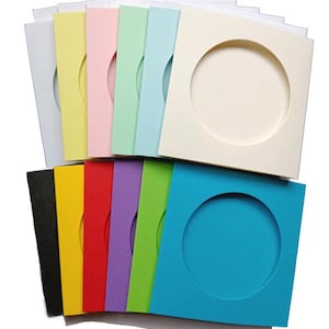 May include: A set of 10 square cards with a round cut-out window in the centre. The cards are in various colours, including white, yellow, pink, light green, blue, black, red, purple, green, and turquoise.