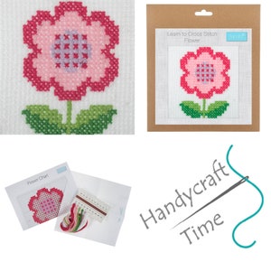 May include: A cross stitch kit featuring a pink flower with green leaves. The kit includes a flower chart, embroidery floss, and a piece of Aida cloth. The packaging includes the text "Learn to Cross Stitch Flower" and "Handycraft Time".