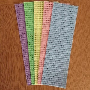 May include: Five rectangular strips of stiffened fabric arranged in a fan shape. The strips feature a distinct grid-like woven texture and come in a variety of pastel colors including purple, light green, yellow, soft pink, and light blue.