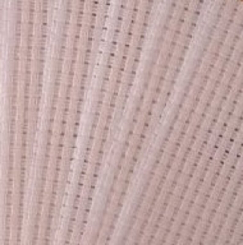 May include: A light pink fabric with a visible grid-like weave pattern. The material features a consistent, repeating square mesh structure throughout, creating a textured surface with small, uniform openings between the interlaced fibers.