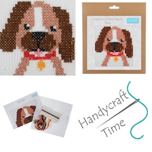 May include: A cross stitch kit featuring a brown and white dog with a red collar and a yellow tag. The kit includes a pre-printed fabric, embroidery floss, and a needle. The kit is labeled "Learn to Cross Stitch Dog" and "Handycraft Time".