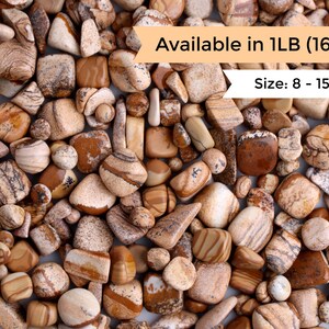May include: A close-up image of a collection of brown and white tumbled stones. The stones are various shapes and sizes, with a range of brown and white patterns. The text "Available in 1LB (16oz) Size: 8 - 15mm" is visible in the image.