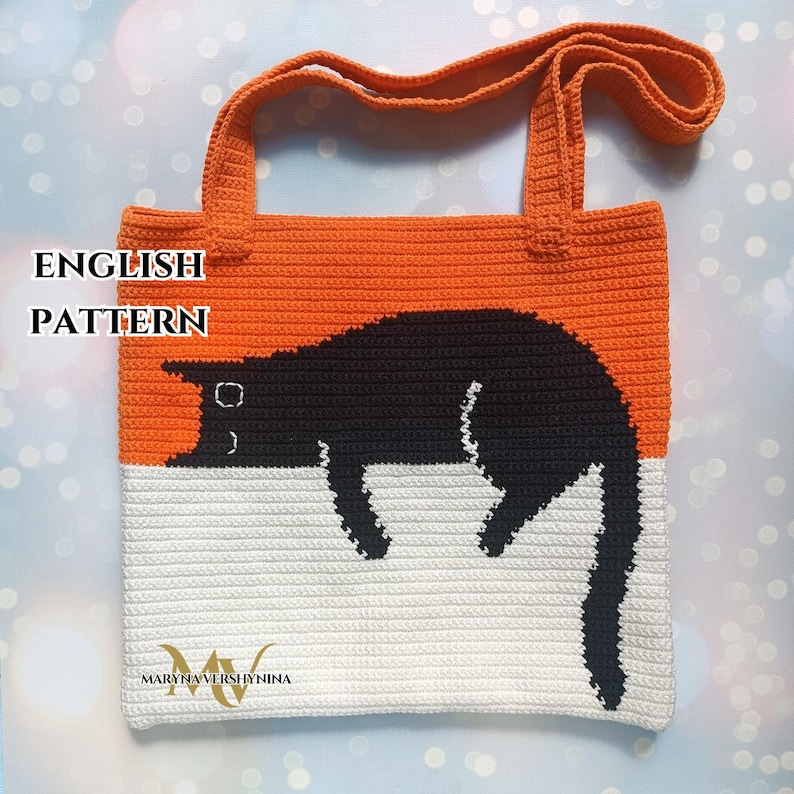 May include: Crochet tote bag with a black cat design. The bag is orange and white with the text "ENGLISH PATTERN" at the top.