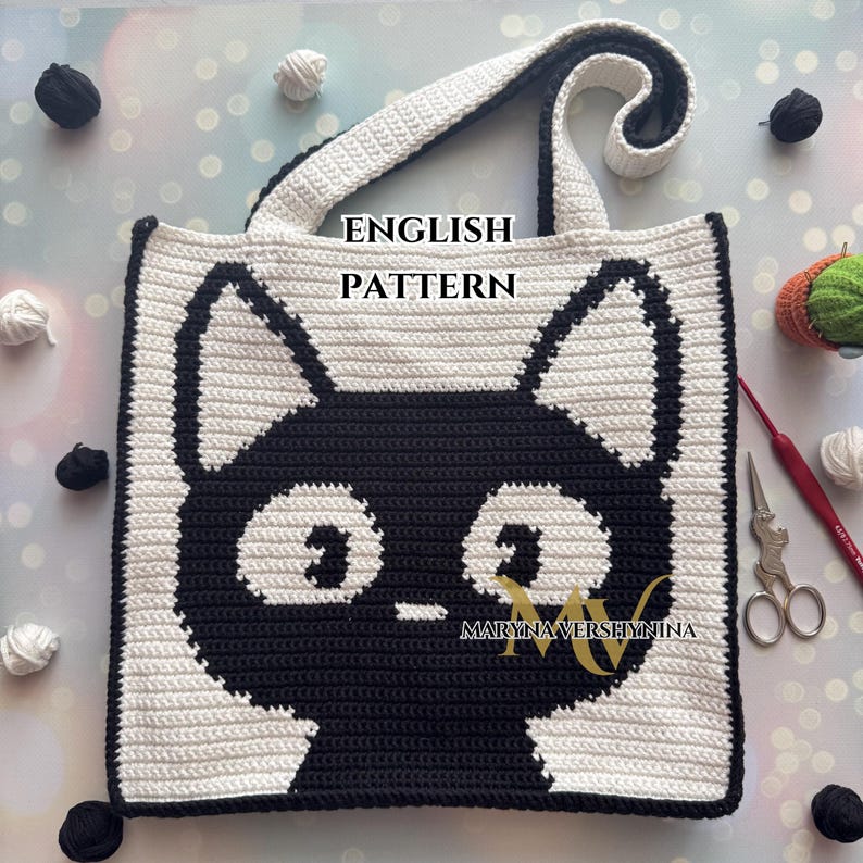 May include: Crochet tote bag pattern featuring a black cat with white eyes. The pattern is written in English and includes the text "ENGLISH PATTERN" and "MARYNA VERSHYNINA".