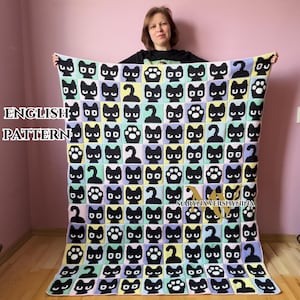 May include: A rectangular crochet blanket featuring a grid pattern of black cat faces, cat paws, and curled cat tails. The background squares alternate between light blue, pale yellow, and soft lavender. The text ENGLISH PATTERN is visible.