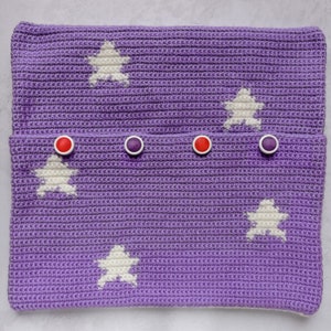 May include: Purple crocheted pouch with white star designs and red and purple buttons.