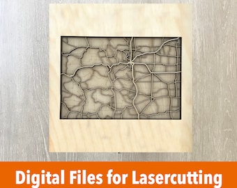 May include: A laser-cut wooden map of a city, framed in a natural wood frame. The map is detailed and intricate, showing the streets and neighborhoods of the city.  Digital files for laser cutting.