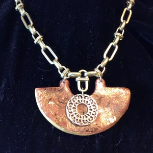 Statement necklace with large iridescent pendant and chunky gold chain