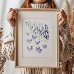 May include: A framed watercolour painting of purple chickens in a field of lavender flowers. The painting is signed "K.C. Knapp" in the bottom right corner.